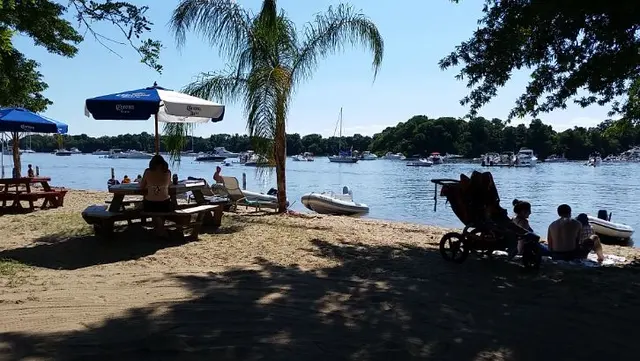 scenic beach view with boats and umbrellas