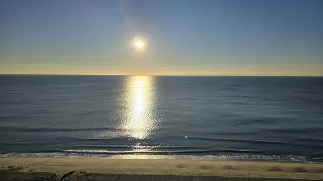 Sunrise breaking over the beach dunes.