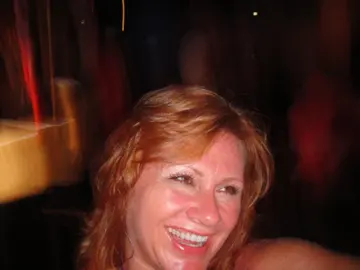 woman laughing closeup blurry nightlife photo