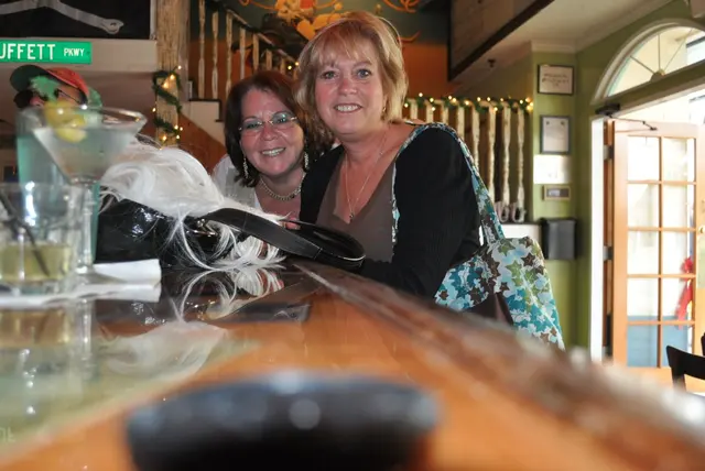 two women smiling at bar