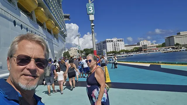 John and Lori dockside with the San Juan skyline behind them.