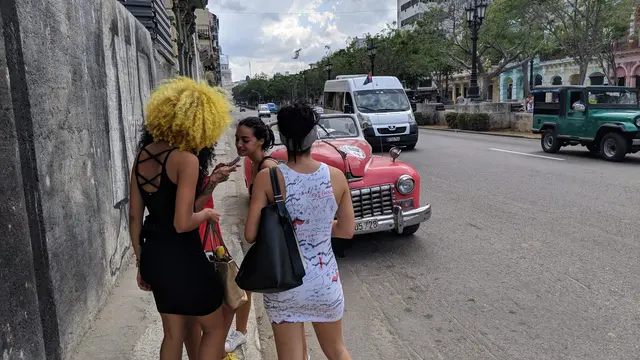 Old Havana street leading toward a Gothic church spire