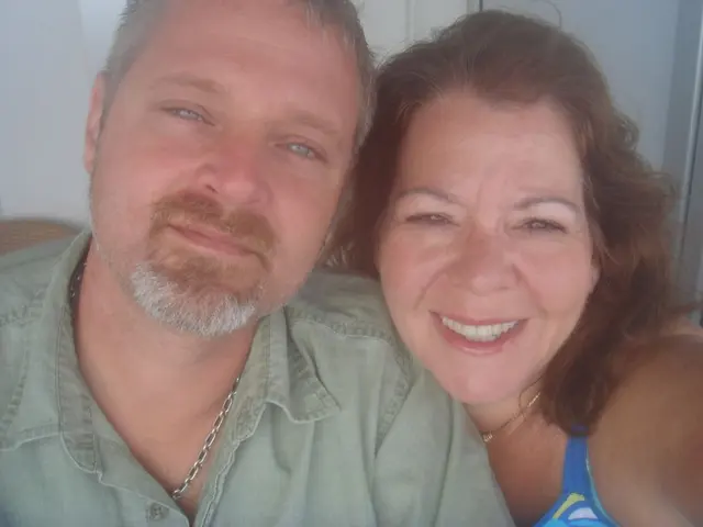 man and woman closeup selfie woman in blue swimsuit top