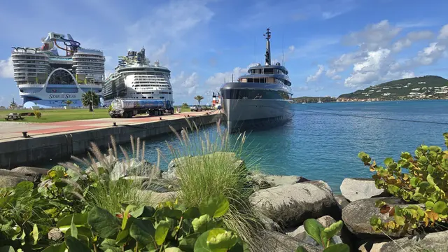 A lineup of cruise ships and a superyacht sharing the port in St. Maarten.
