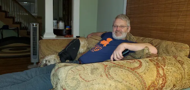 Remote in hand, dog underfoot — a good couch day