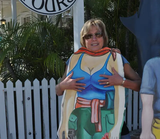 woman posing with painted cutout board